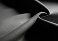 A close-up view of draped black fabric, showcasing a smooth texture with a fine weave. The material\' Royalty Free Stock Photo