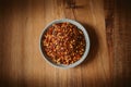 Close up view of dried chili flakes on a bowl. Red cayenne pepper texture. Organic and natural spices. Royalty Free Stock Photo