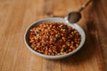 Close up view of dried chili flakes on a bowl. Red cayenne pepper texture. Organic and natural spices. Royalty Free Stock Photo