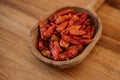 Close up view of dried chili on wooden spoon. Red cayenne pepper. Organic and natural spices. Royalty Free Stock Photo