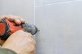 Close up view drilling hole in ceramic tiles on the wall of bathroom