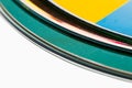 Close up view of edges of colorful compact discs on white background