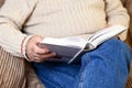 Close up view of Elderly man reading a book, while quarantine at home.