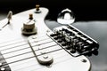 Electronic black and white guitar body close up with strings, volume and tone controls. Music background Royalty Free Stock Photo