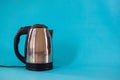 Close up view of electric kettle on blue background Royalty Free Stock Photo