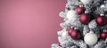 Close-up View of Elegantly Decorated Christmas Tree with Red and White Baubles, on Pink Background Royalty Free Stock Photo