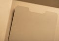 A close-up view of an empty manila folder with a tab. The folder is open, revealing a Royalty Free Stock Photo