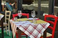 Close up view of empty quaint little restaurant with tables set on the sidewalk