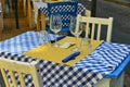 Close up view of empty quaint little restaurant with tables set on the sidewalk