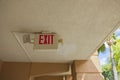 Close up view of EXIT sign for emergency situation under hotel\'s ceiling. Royalty Free Stock Photo