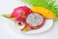 Close up view of exotic dragon fruit with mango cut and whole sliced isolated on white background with leafs and petals Royalty Free Stock Photo