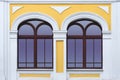 Facade of white yellow ancient building with two arched windows Royalty Free Stock Photo