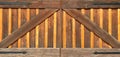 Close-up view of farm barn coral stable wooden wild west gate doors with wrought iron hinges Royalty Free Stock Photo