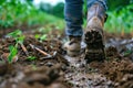 The close up view of farmer walking in the farm while wear dirty boots. AIG43.