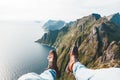 Man tourist sitting on the edge cliff mountains above sea Royalty Free Stock Photo