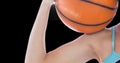 Close up view of female athlete holding a basketball against black background Royalty Free Stock Photo