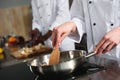 Close-up view of female chef cooking