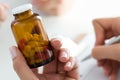 Close-up view of female doctor hand holding bottle with pills Royalty Free Stock Photo