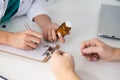 Close-up view of female doctor hand holding bottle with pills Royalty Free Stock Photo