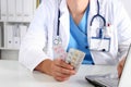 Close-up view of female doctor hand holding bottle with pills and writing prescription. Healthcare, medical pharmacy concept Royalty Free Stock Photo