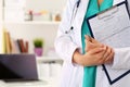 Close up view of female doctor hands holding patient registratio