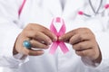 Female doctor holding pink breast cancer ribbon Royalty Free Stock Photo