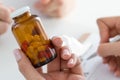 Close-up view of female doctor's hand holding bottle with pills Royalty Free Stock Photo