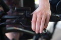 Close-up of Female Hand on Bicycle Brake Lever with E-bike Control on Handlebar Royalty Free Stock Photo