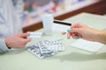 Close-up view of female hand holding credit card and pharmacist Royalty Free Stock Photo