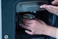 Woman picks up coffee from vending machine Royalty Free Stock Photo