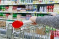 Close up view of a female hand with pushcart in supermarket Royalty Free Stock Photo