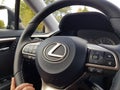 Close up view of female hand on steering wheel of Lexus RX car. Vehicle concept.