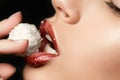 Close up view of female lips eating coconut candy