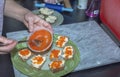 Close up view of female making toasts with red caviar.
