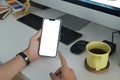 Female office worker using mobile phone at her office desk. Royalty Free Stock Photo