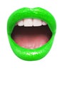 Close-up view of female wearing neon green lipstick with mouth open over white background