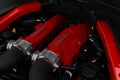 Close-up view of a Ferrari red engine, showcasing its intricate mechanical details