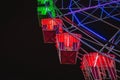 Close-up view Ferris wheel at night. Part of ferris wheel against a dark sky background with lights night lighting. Festive Royalty Free Stock Photo