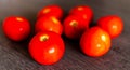 Close up view of a few fresh and just picked tomatoes on a wooden kitchen table Royalty Free Stock Photo