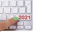 Close up view of a finger pushing on a red 2021 button of computer keyboard. Computer notebook keyboard with 2021 key.