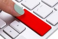 Close up view of a Finger Pushing on a red Button of computer Keyboard. Finger Pressing a Slim Aluminum Keyboard Button. Empty Royalty Free Stock Photo