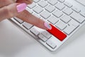 Close up view of a Finger Pushing on a red empty Button on computer Keyboard. Finger Pressing a Slim Aluminium Keyboard Button.