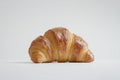 A close-up view of a flaky croissant on a white surface Royalty Free Stock Photo