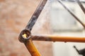 Close-up view of a flame from a torch used to remove paint from a bicycle frame