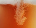 Close up view of floating bubbles in unfiltered beer texture