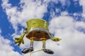 Close up view of foldable sponge Bob figure on blue sky and white clouds background.