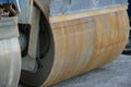 Close up view on forward drum of paver smooth drum roller as a heavy engineering equipment