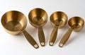 Four Gold Metal Measuring Cups Royalty Free Stock Photo