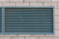 Close-up view of fragment modern industrial building facade and ventilation grille.