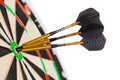 The fragment of the professional sisal dartboard with three gilded darts in center bullseye, isolate on a white Royalty Free Stock Photo